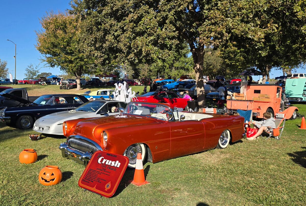 Orange open-top custom with white upholstery and Halloween decorations
