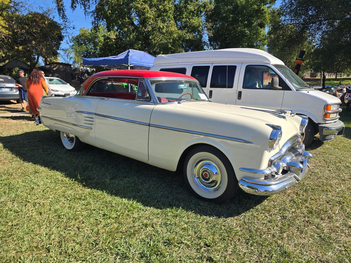 Cream classic hardtop with a dark red roof at Rusch Park