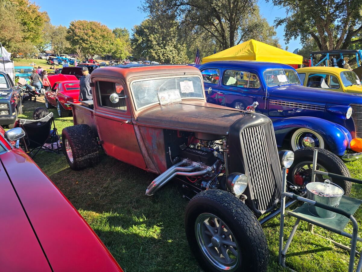 Weathered hot rod pickup with an exposed engine and tall chrome grille