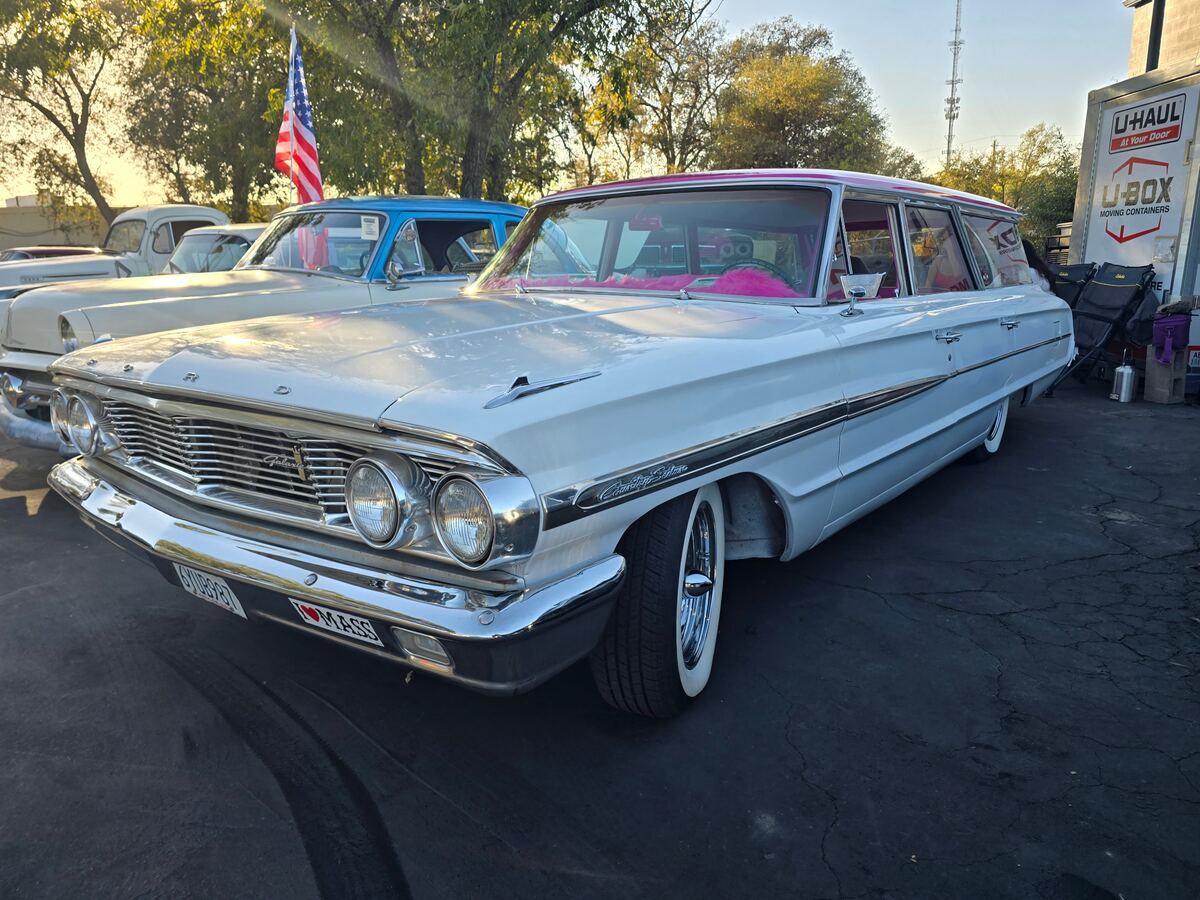 White classic station wagon with pink interior accents