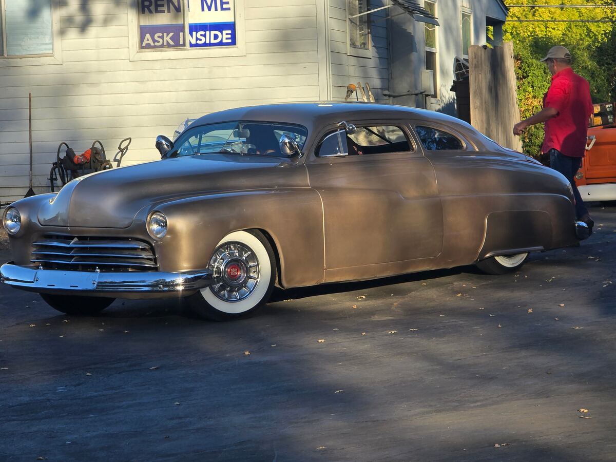 Bronze chopped custom with whitewalls in the afternoon sun